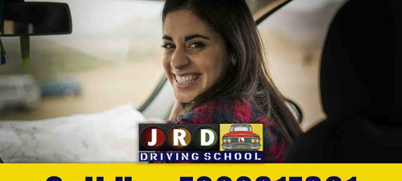A photo of a JRD Motor Driving Training School sign with a backdrop of a well-equipped driving training facility, showcasing the commitment to excellence in driver education.