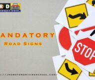 Image featuring a collection of colorful road signs depicting various traffic regulations in India.
